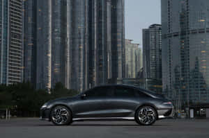 Sleek Black Car Urban Backdrop Wallpaper