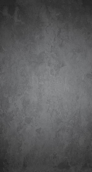 Sleek Grey Iphone On Stained Steel Surface Wallpaper