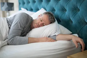 Sleeping Man In White Bed Wallpaper