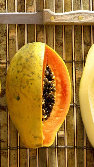 Sliced Fresh Papaya Fruit On Bamboo Mat Wallpaper