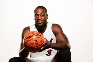 Smiling Dwyane Wade Holding Basketball Wallpaper