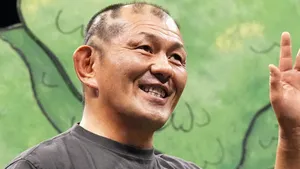 Smiling Man Giving Peace Sign Wallpaper