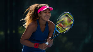 Smiling Naomi Osaka Holding Racket Wallpaper