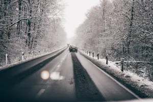 Snowy Road Along Nordic Forest Wallpaper