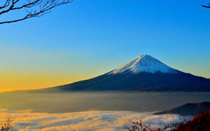 Soaring High Above The World With Snow Covered Mountain Peaks. Wallpaper