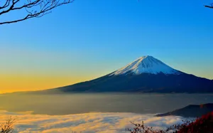 Soaring High Above The World With Snow Covered Mountain Peaks. Wallpaper
