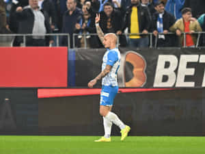 Soccer Player Celebratingon Field Wallpaper