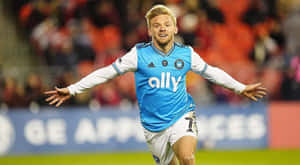 Soccer Player Celebratingon Field Wallpaper