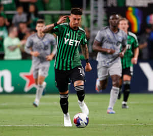 Soccer_ Player_ Controling_ Ball_ During_ Match Wallpaper