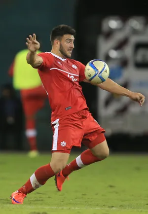 Soccer Player Controling Ball During Match.jpg Wallpaper