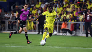 Soccer_ Player_in_ Action_ During_ Match Wallpaper