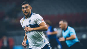 Soccer_ Player_ In_ Action_ On_ Field Wallpaper