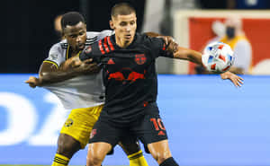 Soccer Players Competingfor Ball Wallpaper