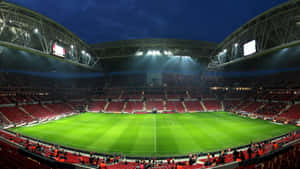 Soccer With A View - Spectacular Stadium Lit Up By A Sunset Wallpaper