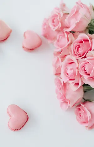 Soft Pink Florals Adorn A Delicate Greenery Wallpaper