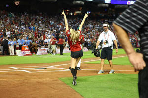 Softball Player Celebrating On The Field Wallpaper