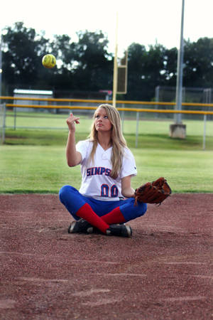 Softball Player Throwing The Ball Wallpaper