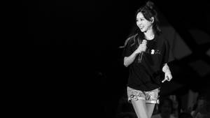 South Korean Pop Singer, Taeyeon, Electrifying Performance At A Concert Wallpaper