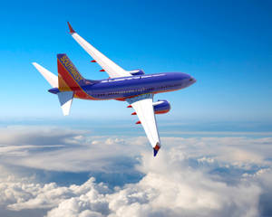 Southwest Airlines Plane Above The Clouds Wallpaper