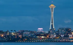 Space Needle Towering Over Buildings Wallpaper