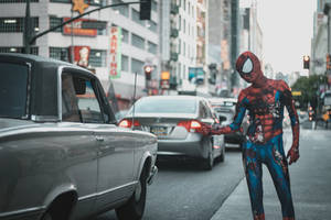 Spiderman Swinging Through The Concrete Jungle Wallpaper