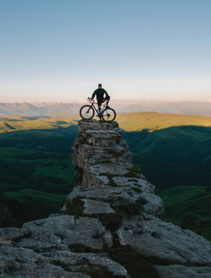 Sport Biker On A Cliff Wallpaper