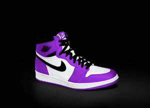 Stand Out Of The Crowd With These Iconic Purple Jordans Wallpaper