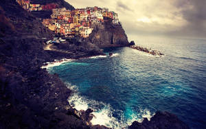 Standing Atop An Ocean Cliff With A Macbook Wallpaper