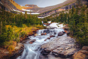 Standing In Awe Of The Majestic Beauty Of A Cascading Waterfall Wallpaper