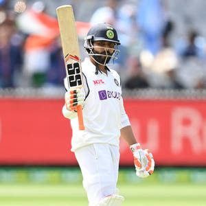 Standing Ravindra Jadeja Holding A Bat Wallpaper