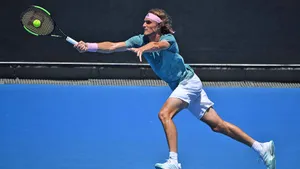 Stefanos Tsitsipas Reaching For Tennis Ball Wallpaper