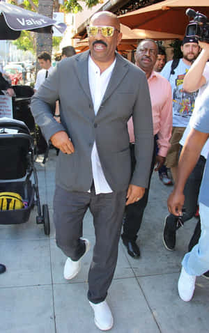 Steve Harvey Walking In A Gray Suit Wallpaper