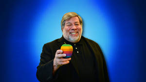 Steve Wozniak Holding An Iconic Colored Apple Logo. Wallpaper