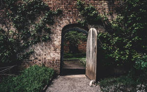 Stone Wall With Arched Door Wallpaper