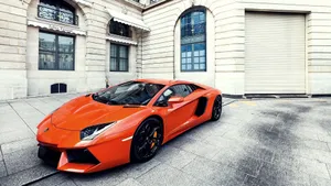 Streets Of London Lit Up By An Orange Lamborghini Aventador Wallpaper