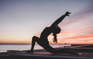 Stretching In The Shade For An Improved Fitness Routine. Wallpaper