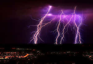 Striking Purple Lightning Over City Wallpaper
