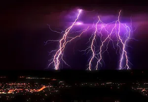 Striking Purple Lightning Over City Wallpaper