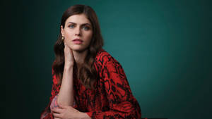 Stunning Actress Alexandra Daddario Wearing A Shiny Pink Dress Wallpaper