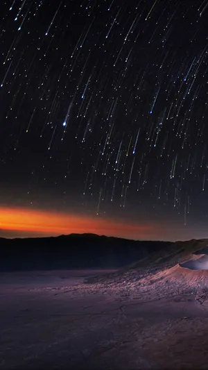 Stunning Meteor Shower In The Night Sky Wallpaper