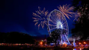 Stunning View Of Illuminated Ferris Wheel In Monterrey At Dusk Wallpaper