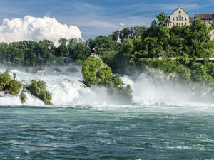 Stunning Waterfall Amidst A Serene Nature Space Wallpaper