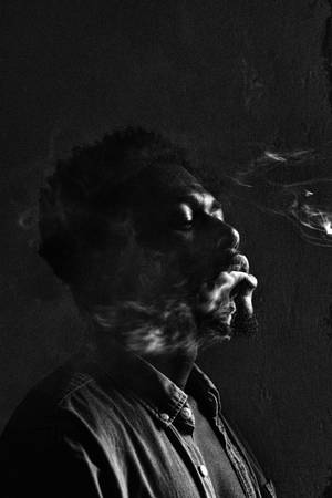 Stylish Black Bearded Man Smoking Wallpaper