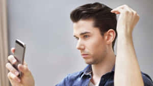 Stylish Man Obsessively Adjusting His Hair In The Mirror Wallpaper