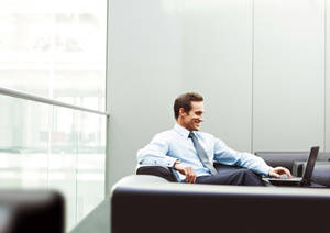 Successful Entrepreneur Contemplating Next Move In Office Wallpaper