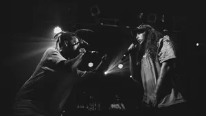 Suicideboys Singing Together On Stage Wallpaper