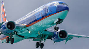 Sun Country's Majestic Flight At Sunset Wallpaper