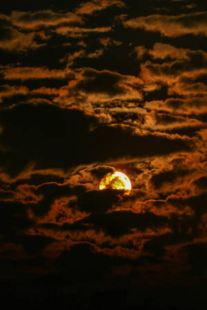 Sun In Dark Clouds Wallpaper