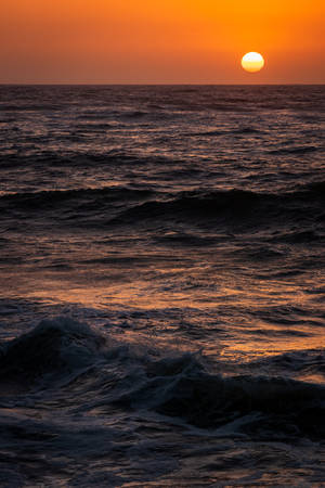 Sun Over Raging Seas Wallpaper