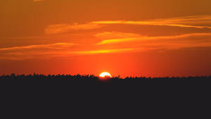 Sun Setting Down Over Plains Wallpaper